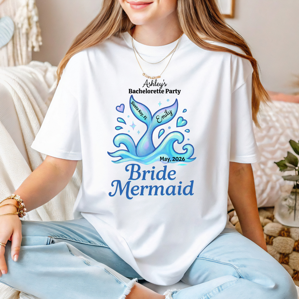 Person wearing a white t-shirt with a bride mermaid design and text.