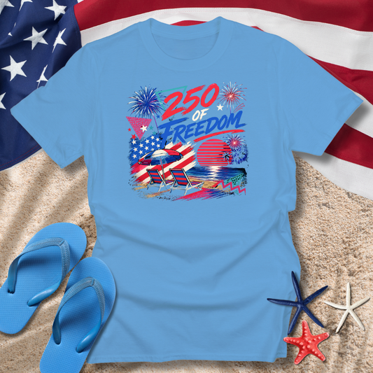 Blue t-shirt with '250 of Freedom' graphic on a sandy background with American flag, flip-flops, and starfish.
