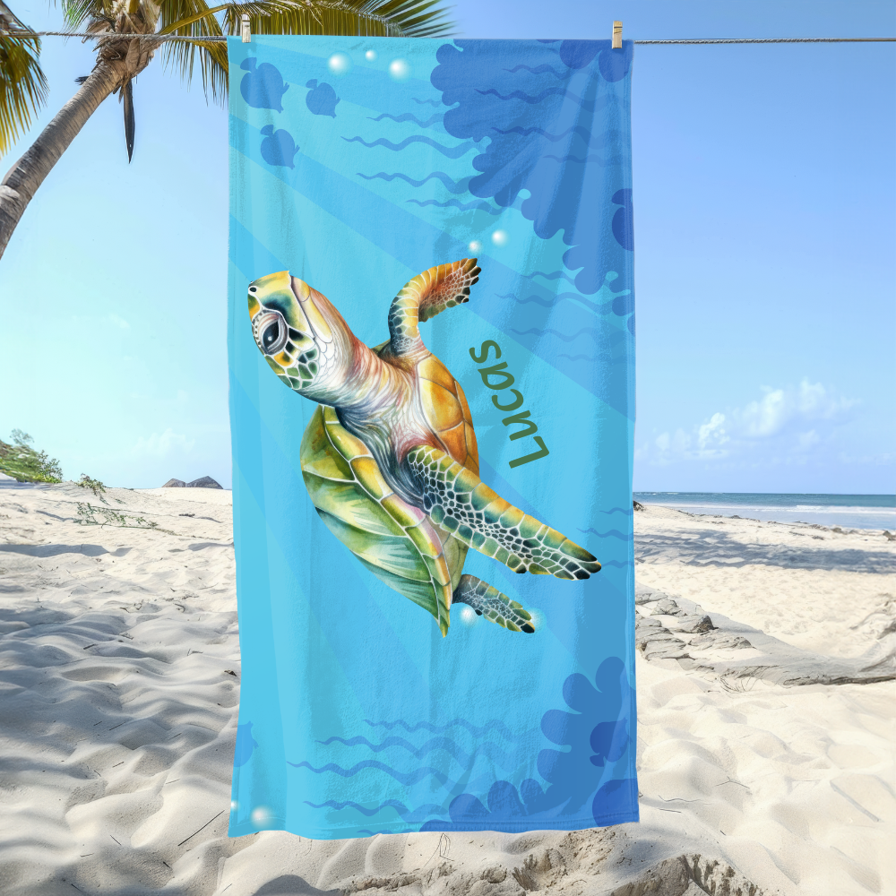 Beach towel with a turtle design on a sandy beach with palm trees.
