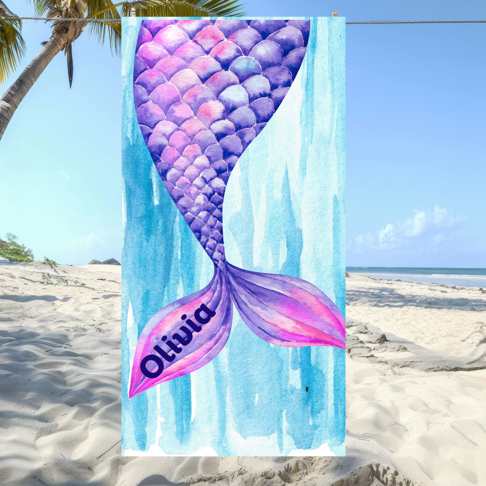 Mermaid tail towel with 'Olivia' on a beach