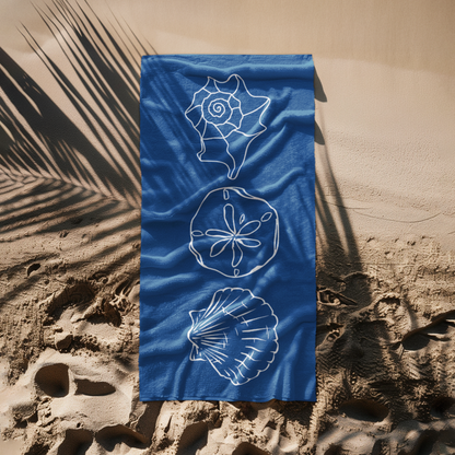 Navy blue beach towel with white seashell and sand dollar outlines