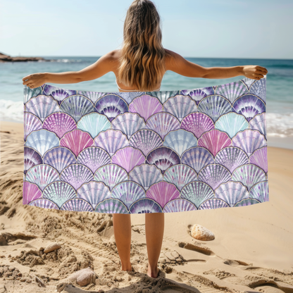 Beach towel with pastel seashell pattern in purple, blue, and pink