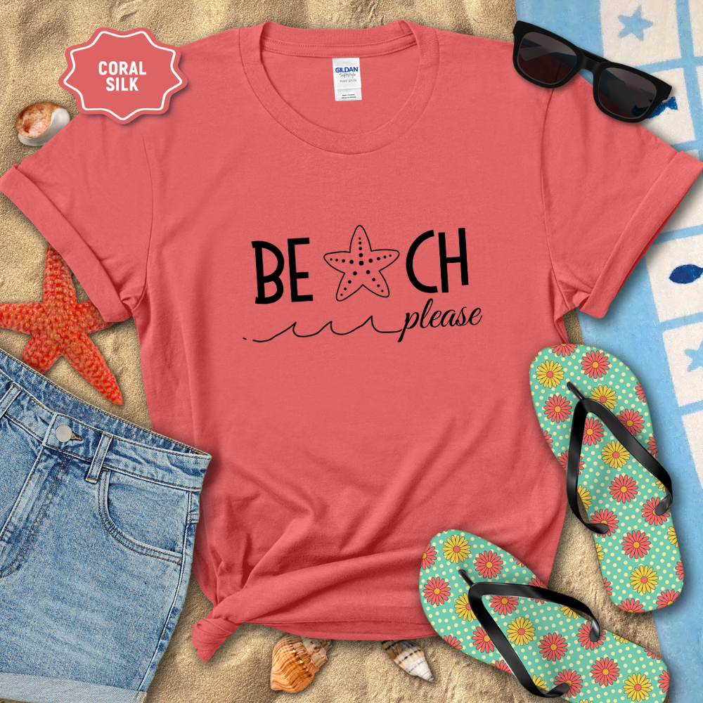 Coral t-shirt with 'Beach Please' text, sunglasses, flip-flops, and beach accessories on sand.