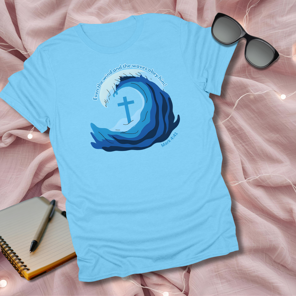 Light blue t-shirt with a wave and cross design on a pink fabric background