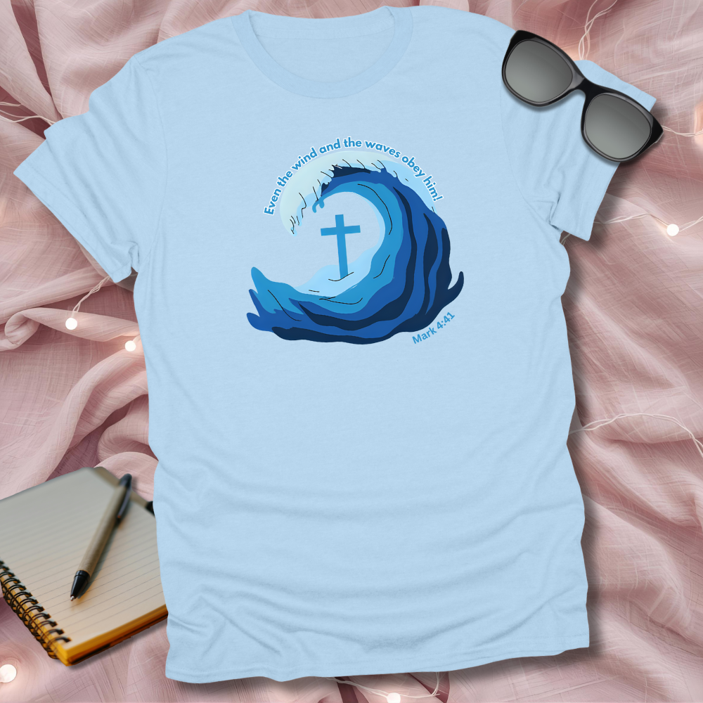 Light blue t-shirt with a wave and cross design on a pink fabric background