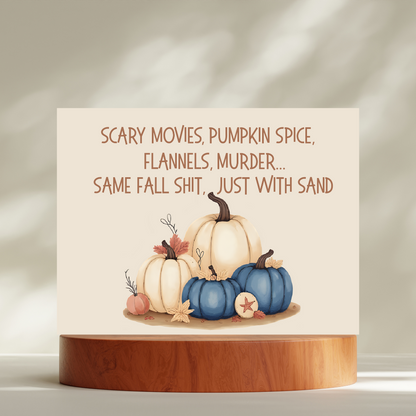 Card with pumpkins and humorous text on a wooden stand against a neutral background