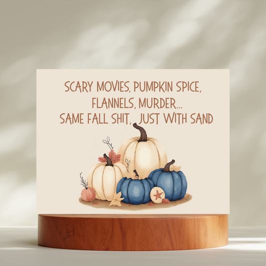 Card with pumpkins and humorous text on a wooden stand against a neutral background