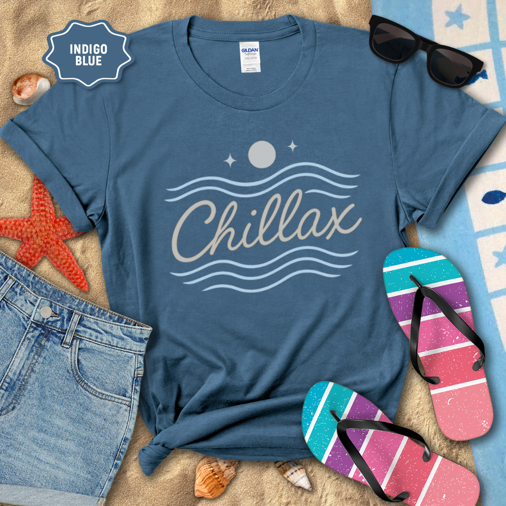 Blue t-shirt with 'Chillax' design on a beach setting with sunglasses, flip-flops, and denim shorts.
