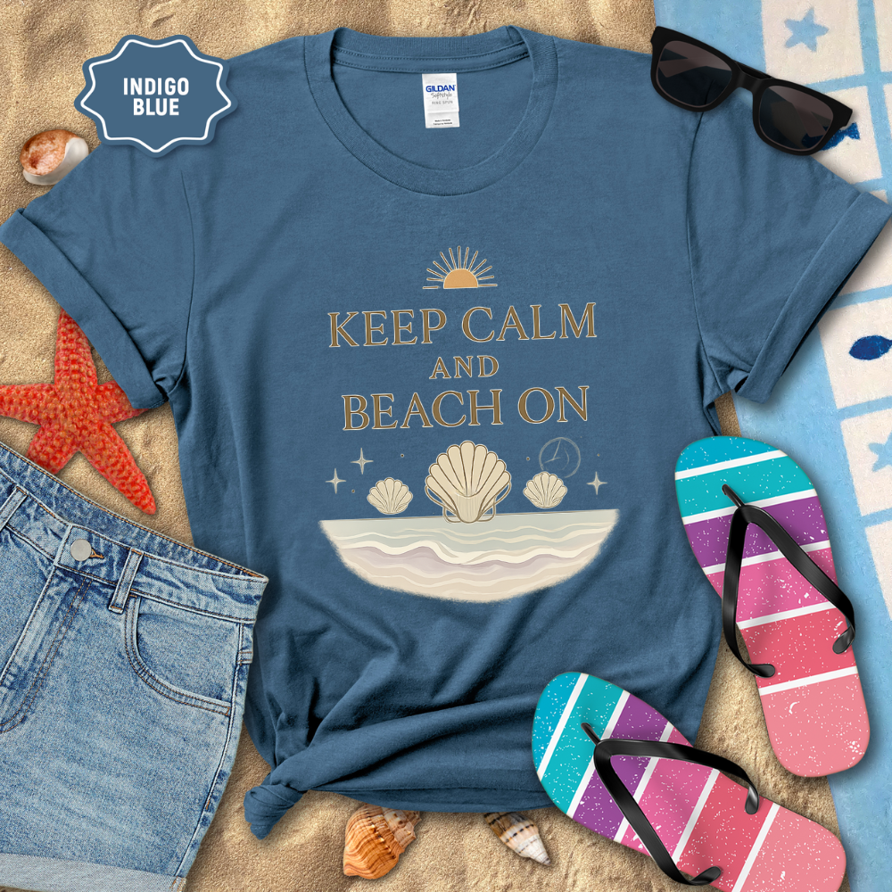 Indigo blue t-shirt with beach-themed design and accessories on a sandy background