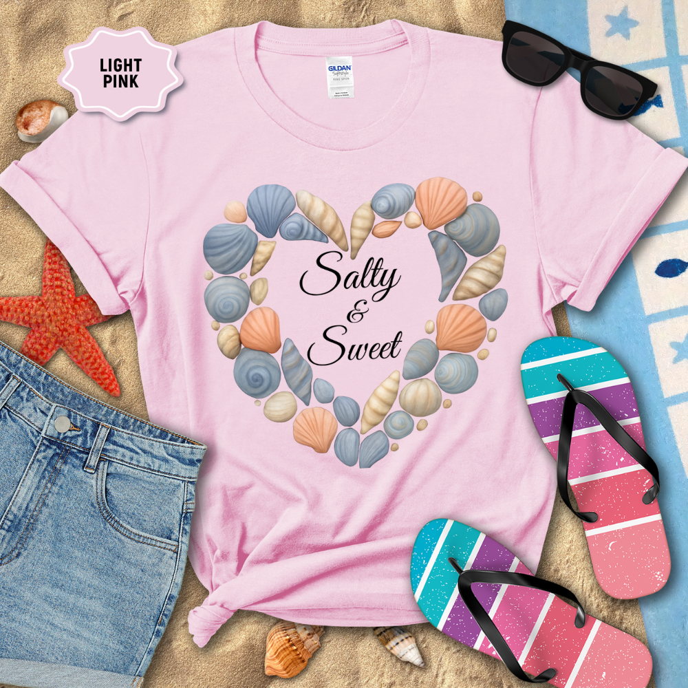 Light pink t-shirt with seashell design and 'Salty & Sweet' text, surrounded by beach-themed items.