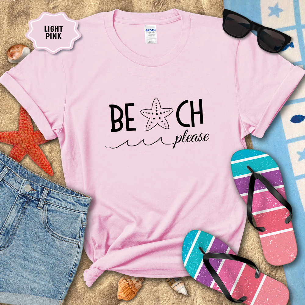 Light pink t-shirt with 'BEACH please' text, sunglasses, and flip-flops on a sandy background