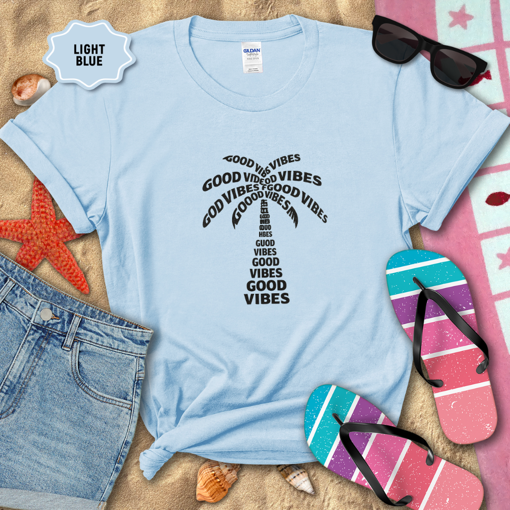 Light blue t-shirt with 'Good Vibes' text on a sandy background with flip-flops and sunglasses.