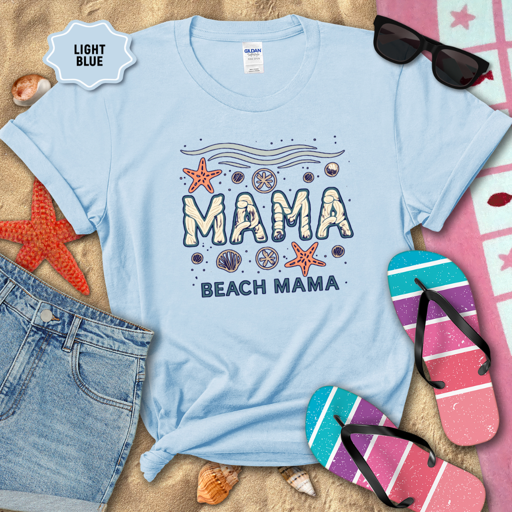 Light blue t-shirt with 'Mama Beach Mama' text and beach-themed graphics on sand with flip-flops and sunglasses.