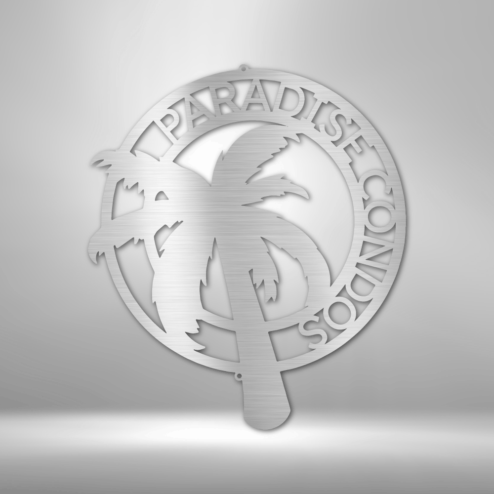 Metallic decorative wall art with palm tree and text on a gray background