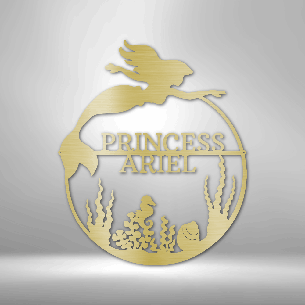 Gold decorative wall art with 'Princess Ariel' on a gray background