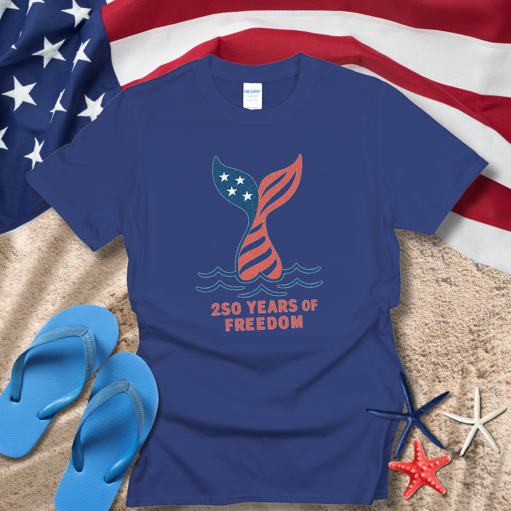 Blue t-shirt with '250 Years of Freedom' design on a sand and flag background