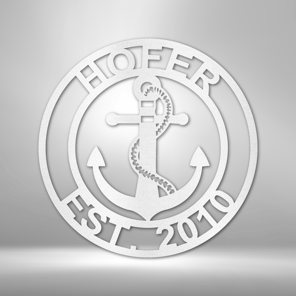 Decorative metal sign with anchor design and text on a gray background