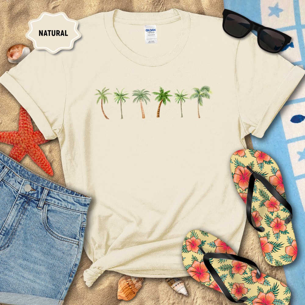 Beige t-shirt with 'Unity in Diversity' design on a sandy background with beach accessories.