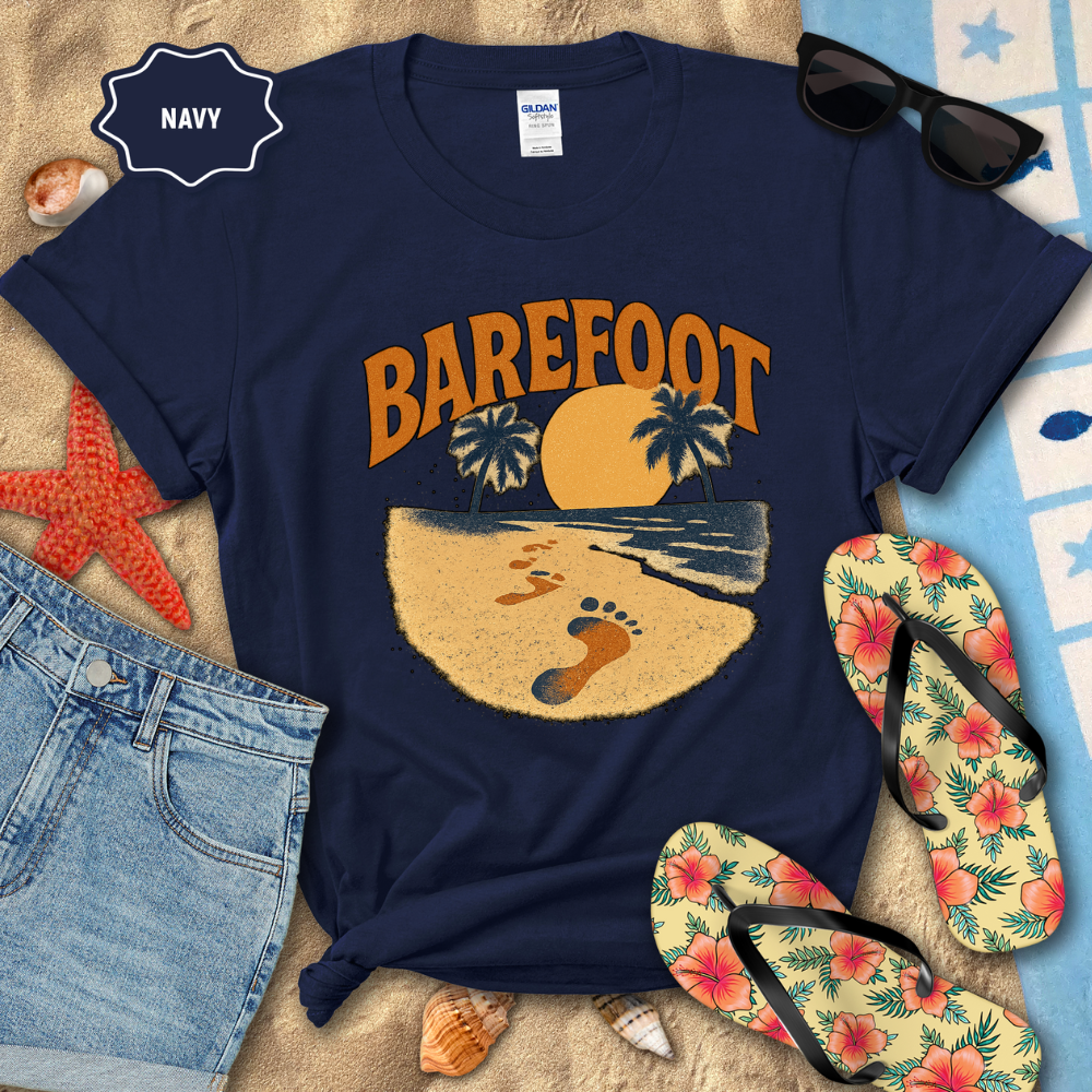 Navy t-shirt with 'Barefoot' graphic design on a beach-themed background with flip-flops and sunglasses.