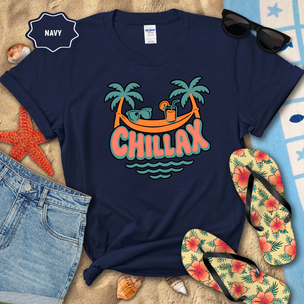 Navy t-shirt with 'Chillax' graphic design on a beach-themed background with flip-flops and sunglasses.