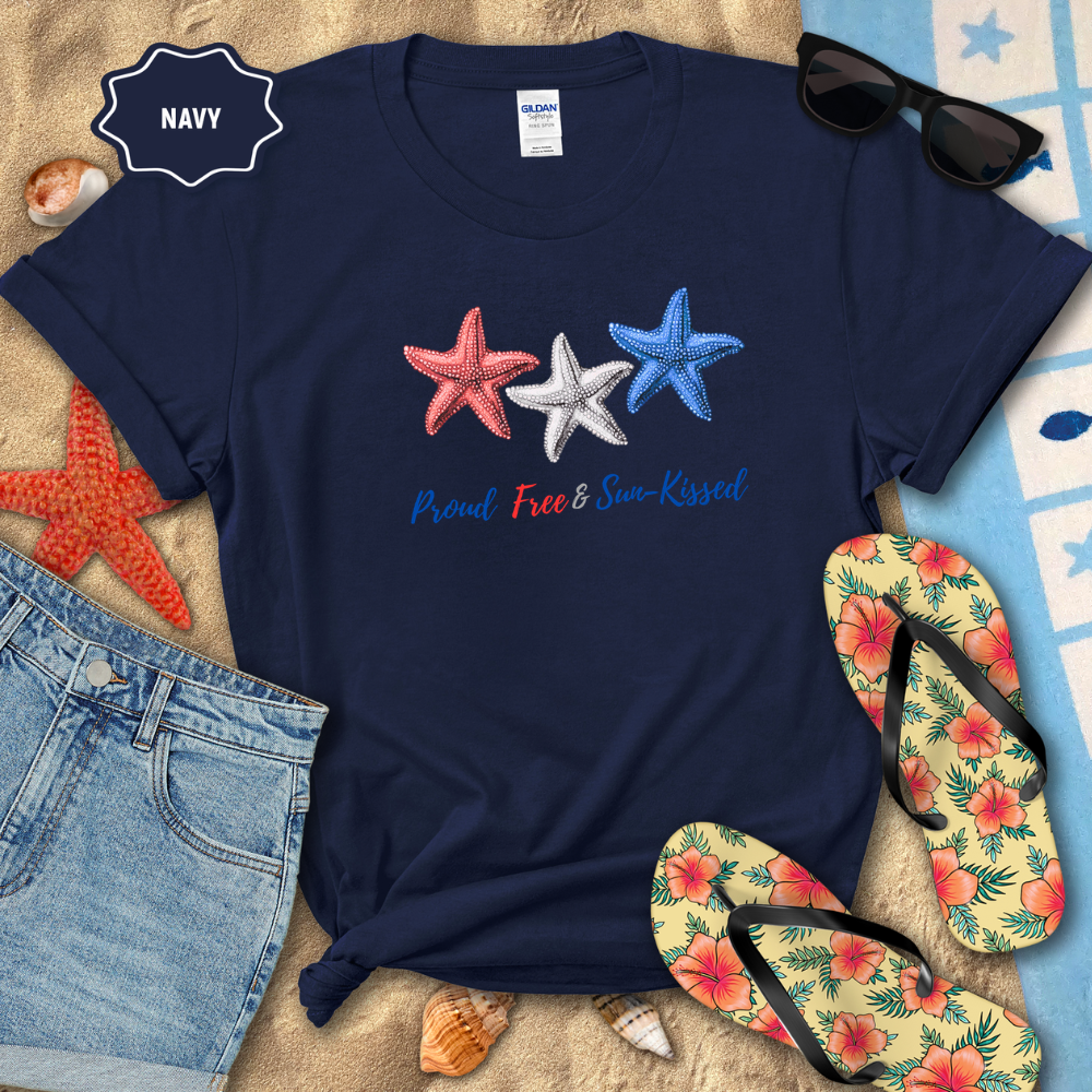 Navy t-shirt with star designs and text on a beach setting with sunglasses, flip-flops, and starfish.