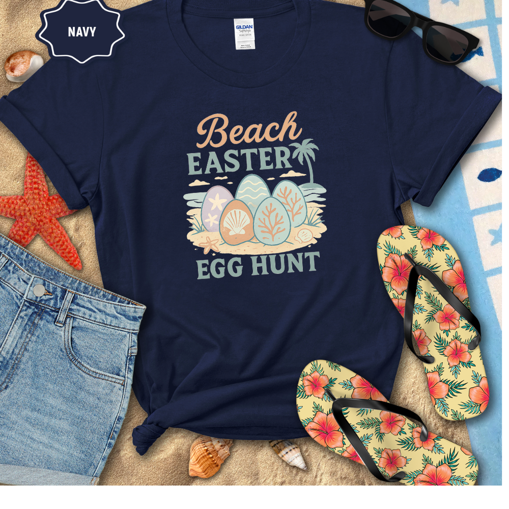 Navy t-shirt with 'Beach Easter Egg Hunt' design, surrounded by beach-themed accessories.