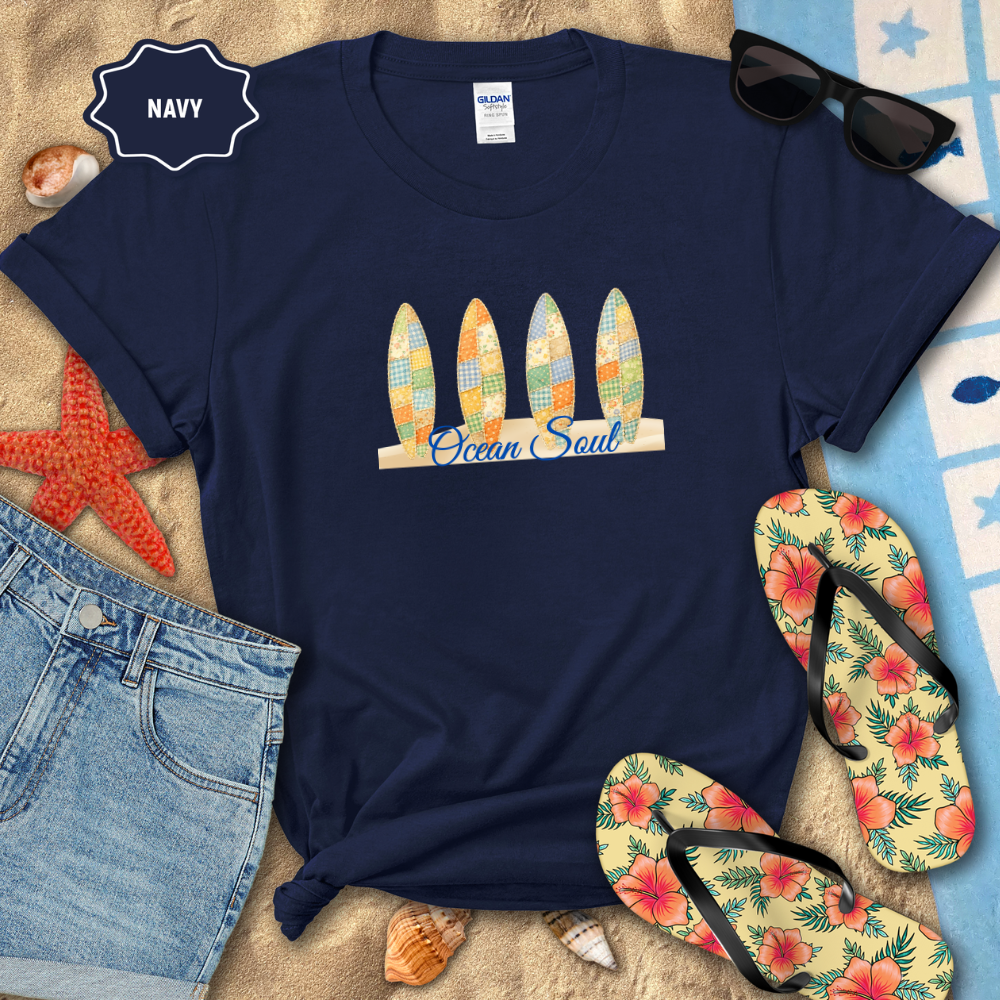 Navy t-shirt with 'Ocean Soul' design on a beach setting with flip-flops and sunglasses.