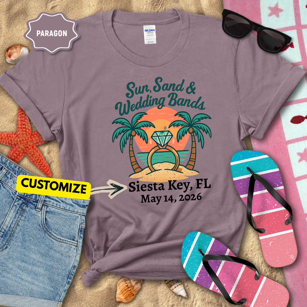Purple t-shirt with beach-themed design and customizable text, surrounded by beach accessories.