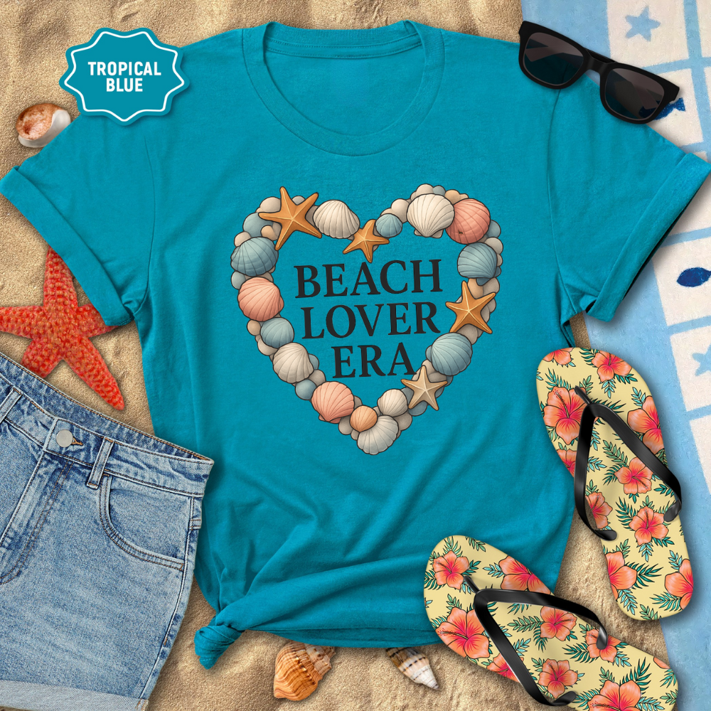 Turquoise t-shirt with 'Beach Lover Era' design on a sandy background with flip-flops and sunglasses.