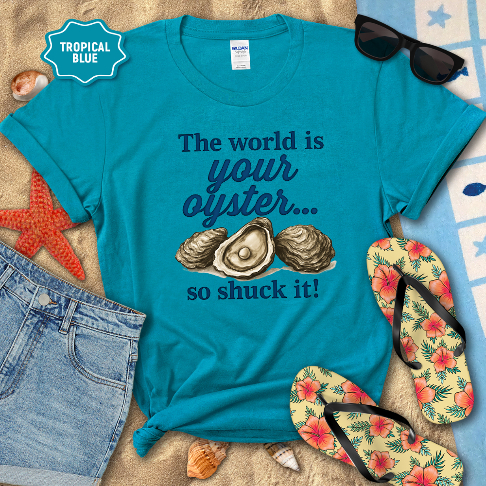 Turquoise t-shirt with oyster graphic and text on a beach setting