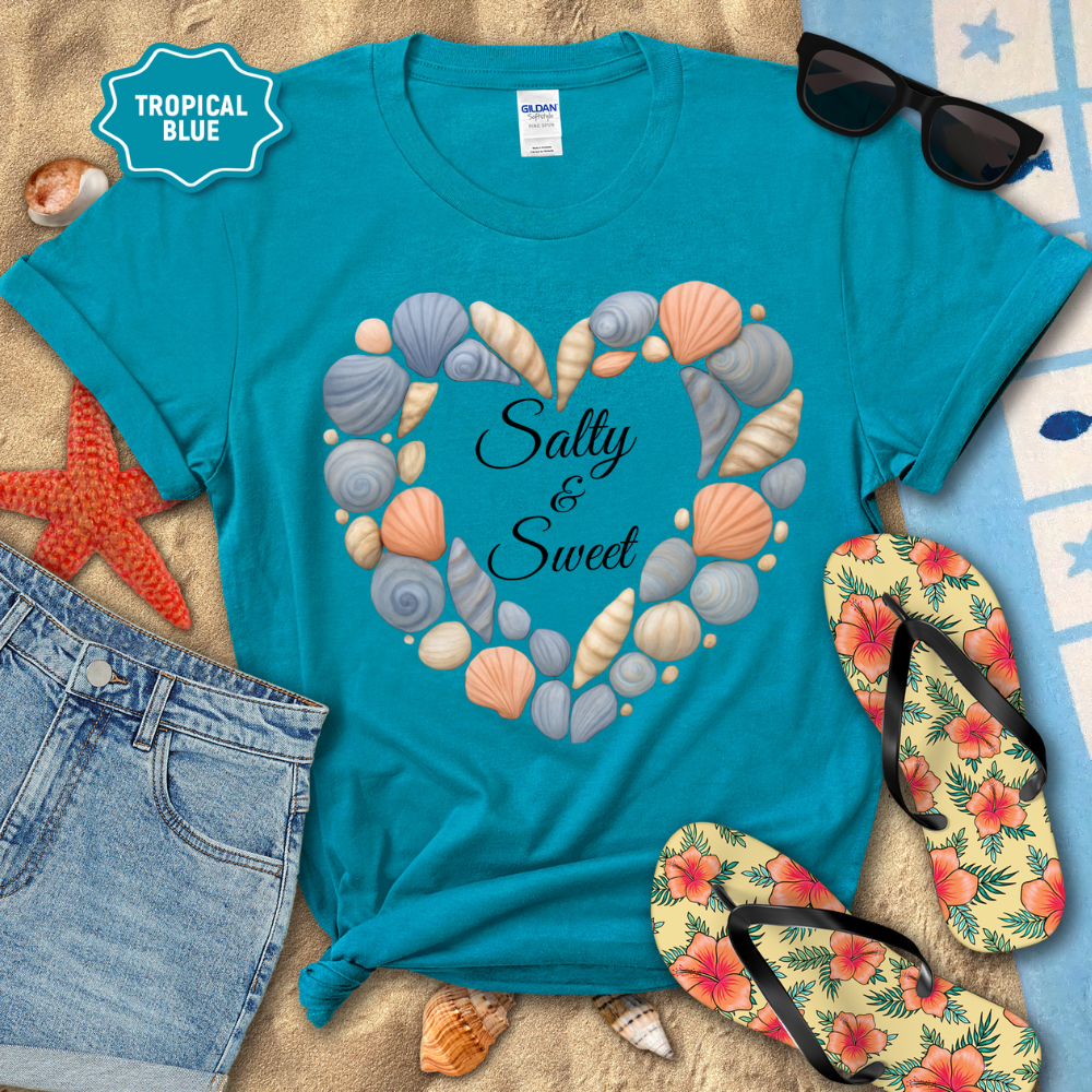 Turquoise t-shirt with seashell heart design and 'Salty & Sweet' text, surrounded by beach-themed items.