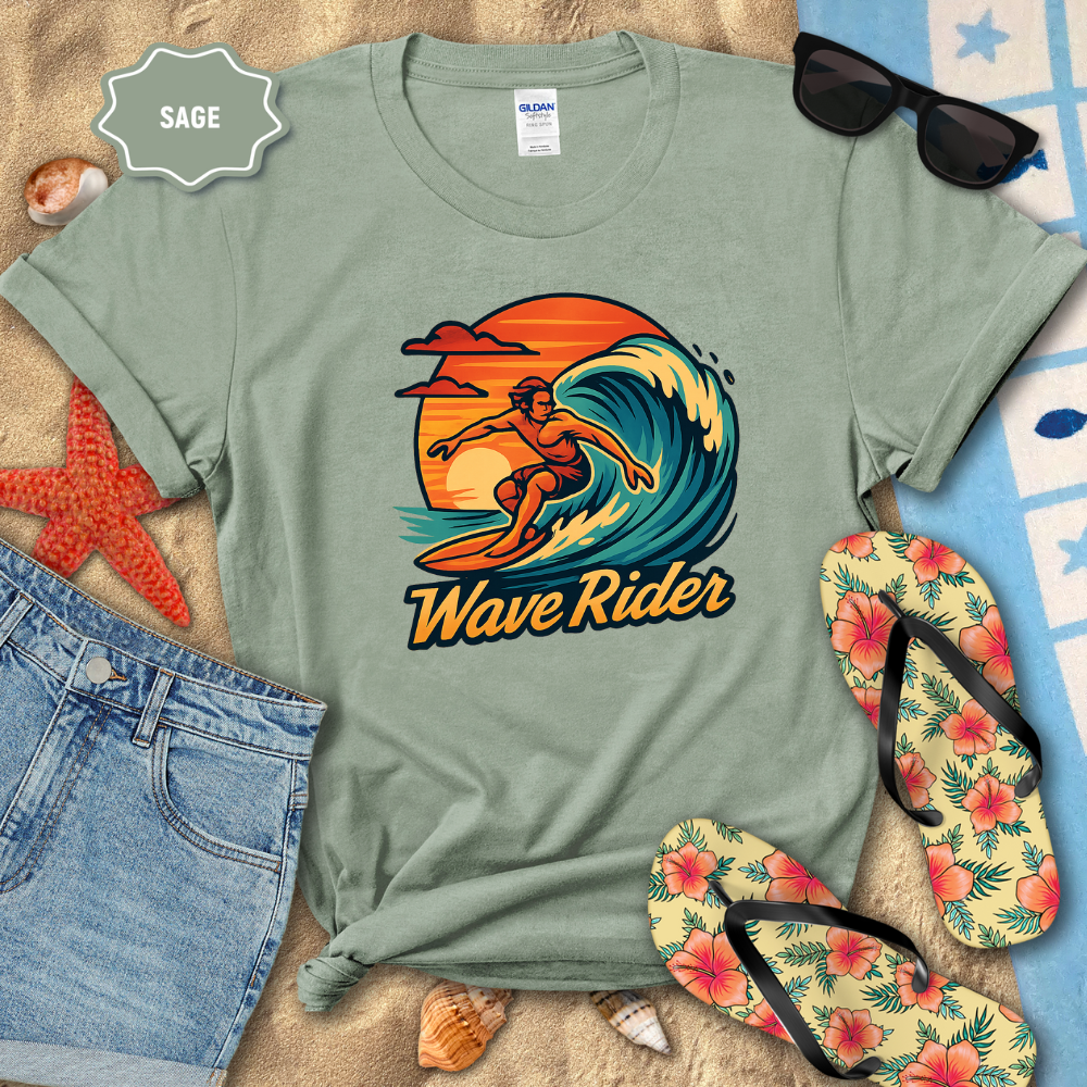 Sage green t-shirt with 'Wave Rider' graphic design on a beach setting with sunglasses, flip-flops, and starfish.