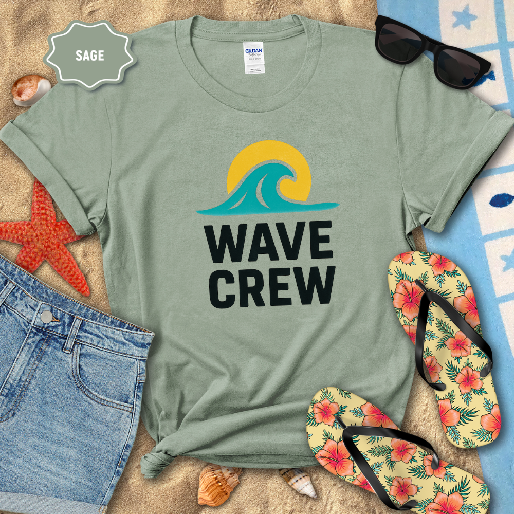 Sage green t-shirt with 'Wave Crew' design on a beach setting with sunglasses, flip-flops, and starfish.
