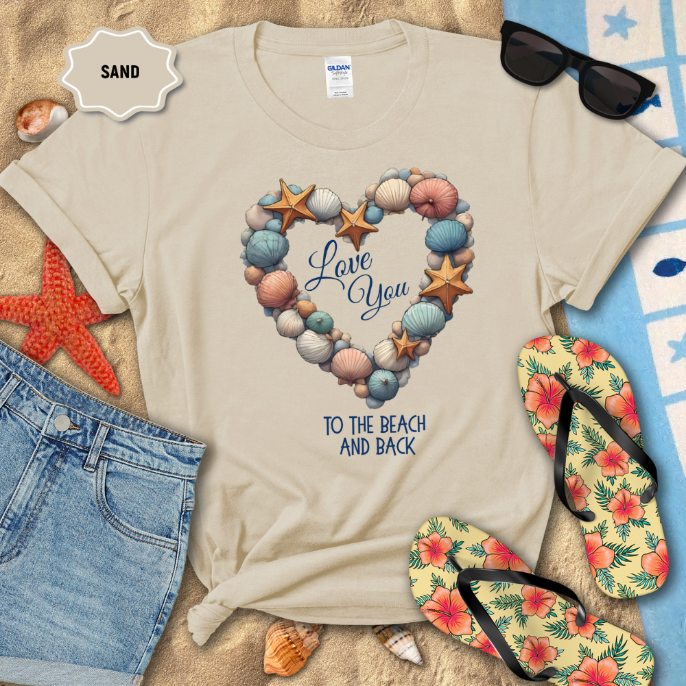 Beige t-shirt with beach-themed design on sand with sunglasses, flip-flops, and starfish.