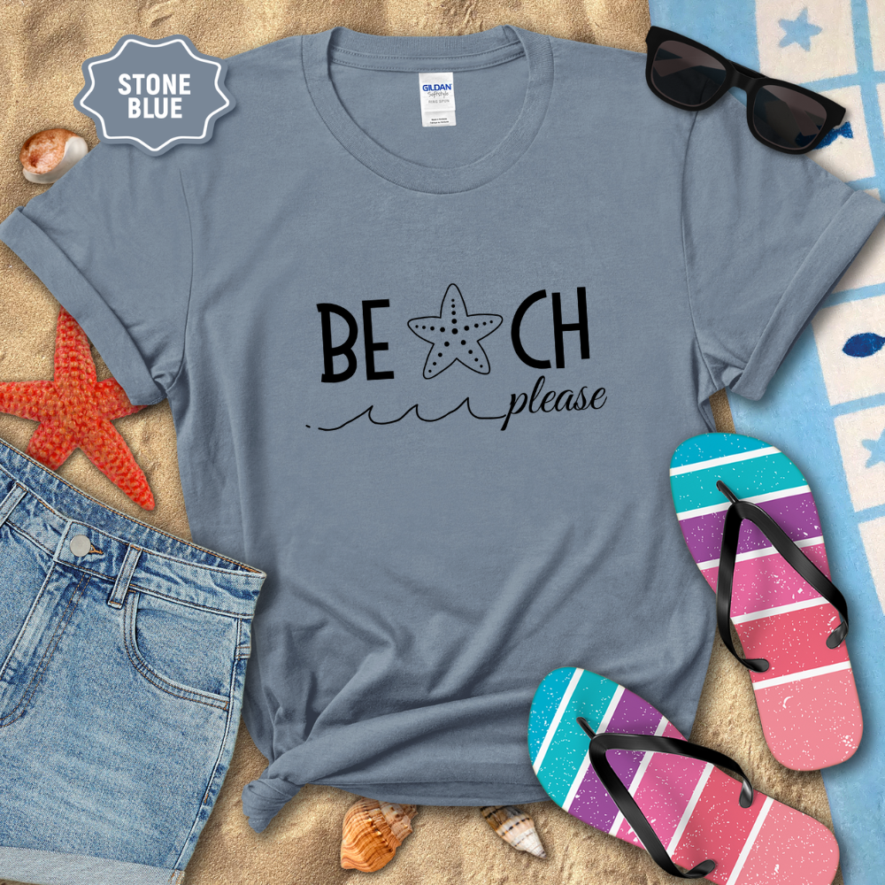 Stone blue t-shirt with 'Beach Please' text on a sandy background with beach accessories.