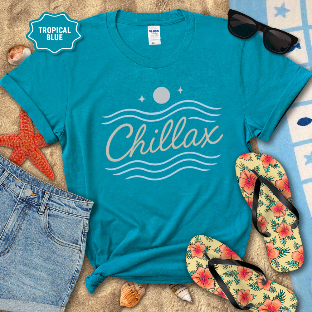 Blue t-shirt with 'Chillax' design on a beach setting with flip-flops and sunglasses.