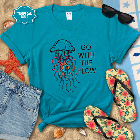 Blue t-shirt with jellyfish design and 'Go With The Flow' text, surrounded by beach accessories.