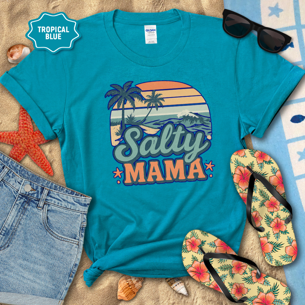 Turquoise t-shirt with 'Salty Mama' design on a sandy background with flip-flops and sunglasses.