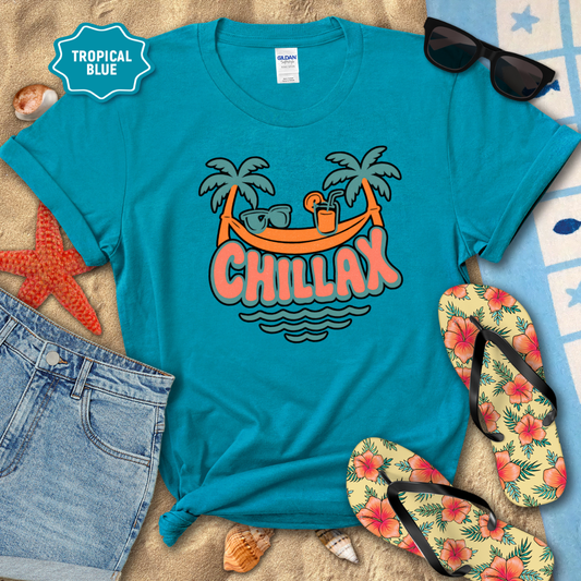 Blue t-shirt with 'Chillax' design on a beach setting with sunglasses, flip-flops, and starfish.