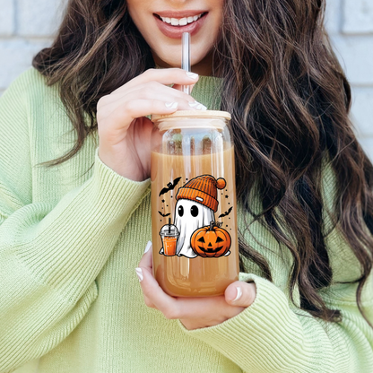 A person holding a 16oz clear glass sipper with a festive Halloween ghost design and an orange beanie.