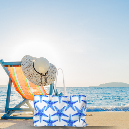 Oversized beach tote with bold blue starfish pattern on white background