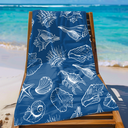 White beach towel with blue striped fish pattern on lounge chair