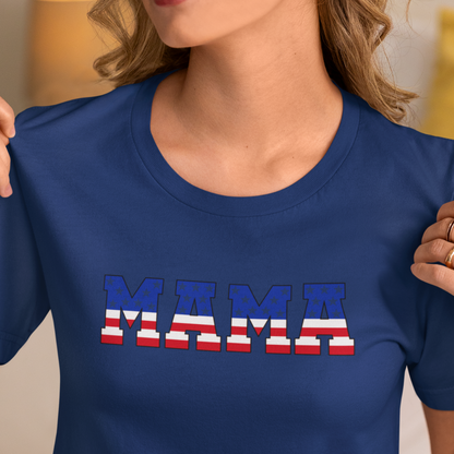 Woman wearing a navy  blue T-shirt with “MAMA” in American flag print across the chest, showcasing a patriotic and stylish design.