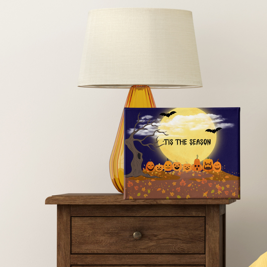 Halloween-themed decorative box on a wooden table with a lamp in the background