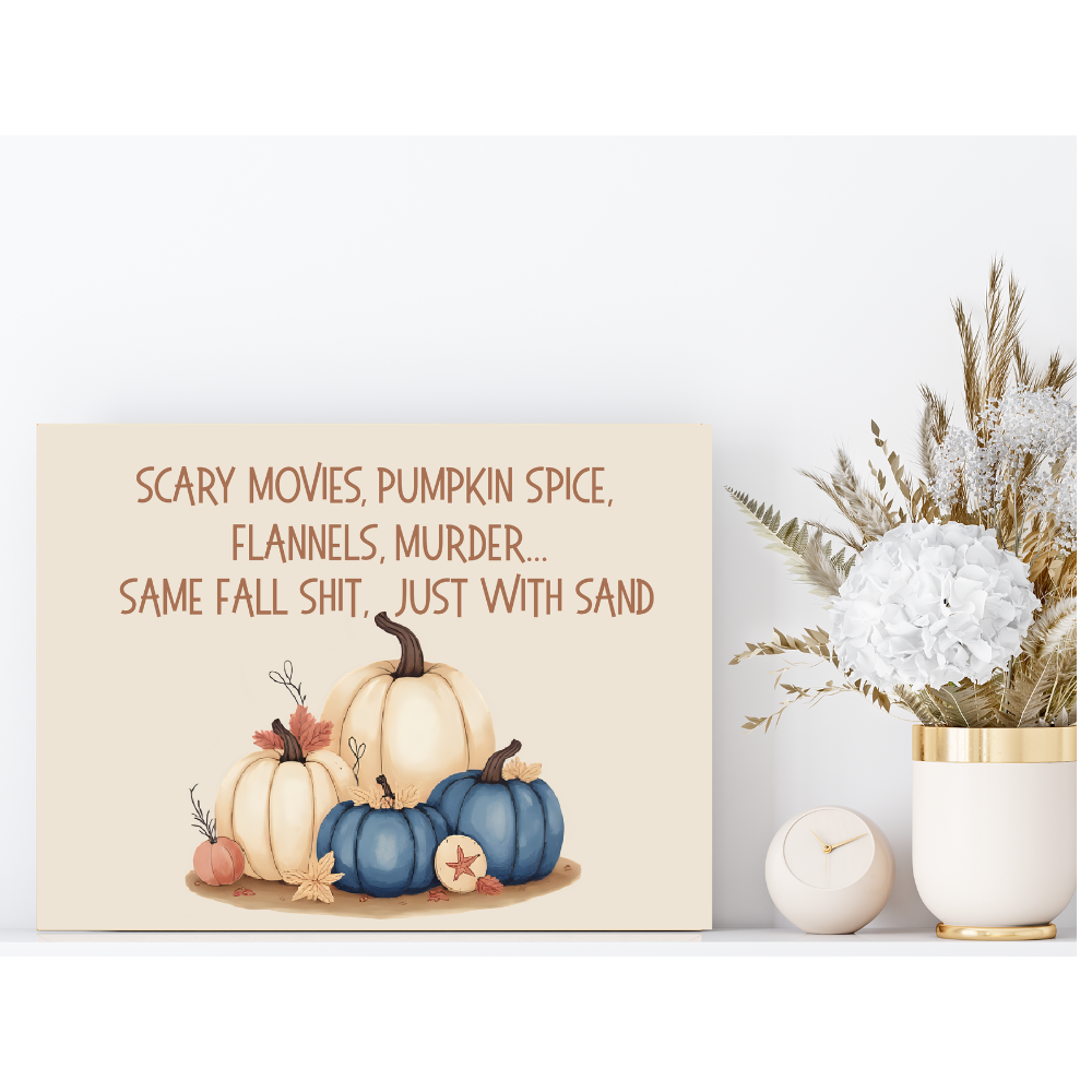 Decorative sign with pumpkins and text next to a vase with flowers on a white background