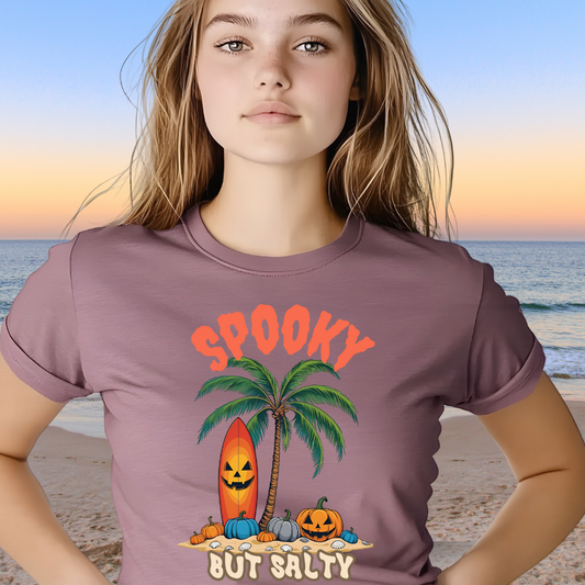 Person wearing a t-shirt with a Halloween design on a beach
