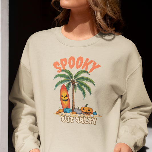 Sweatshirt with 'Spooky But Salty' graphic design featuring a palm tree and surfboard.