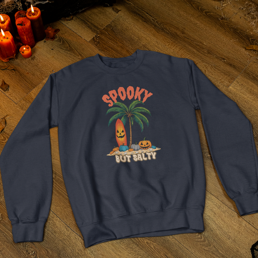 Navy blue sweatshirt with Halloween-themed design on a wooden floor.