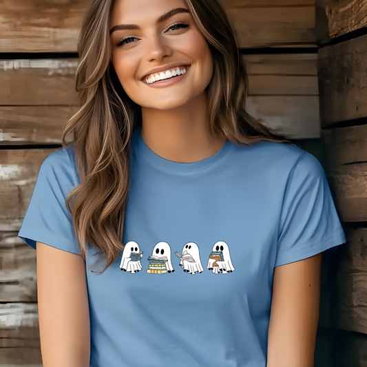 Woman wearing a blue t-shirt with cartoon ghosts designs against a wooden background