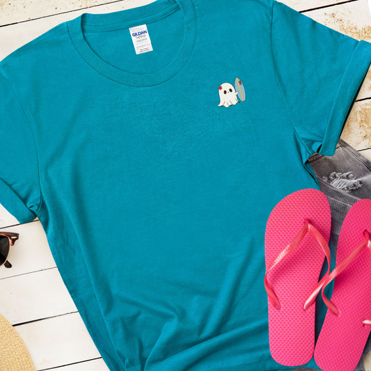 Blue t-shirt with a ghost design and pink flip-flops on a wooden surface